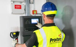 Protec Service Engineer working on panel