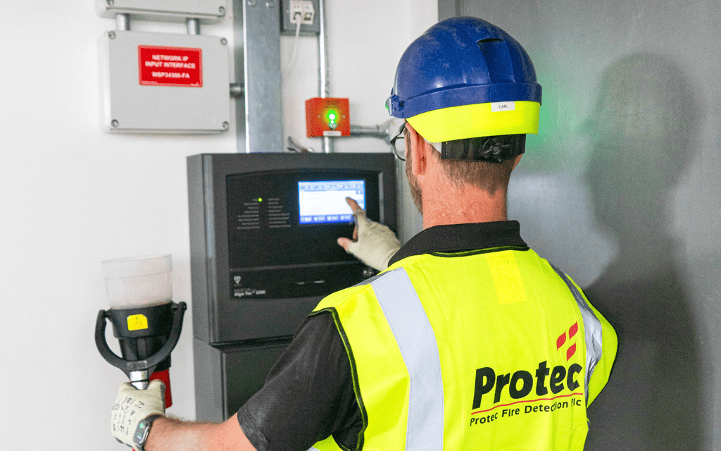Protec Service Engineer working on panel